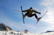 Jumping alpine skier in mountains