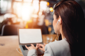 Closeup of an beautiful girl using laptop. Copyspace.