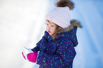 Wall Mural - Little cute toddler girl outdoors on a sunny winter day.