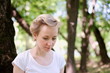 © romeo3131 - Woman typing on a laptop in the forest