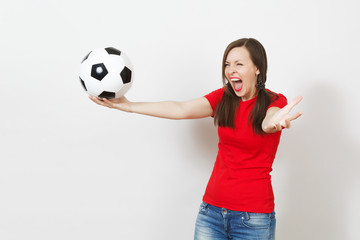 Overjoyed European young woman, two fun pony tails, football fan or player in red uniform holding classic soccer ball isolated on white background. Sport football health, healthy lifestyle concept.