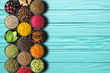 Set of seasonings on a turquoise table with empty space