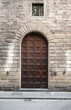 Large wooden door in old limestone wall
