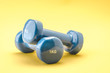equipment for fitness class/blue dumbbells on a yellow background