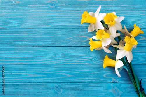 Daffodils bouquet on blue wooden table