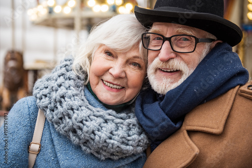 Fotografie, Obraz Portrait of joyful senior married couple hugging while relaxing outdoor