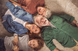 © Yakobchuk Olena - Top view portrait of cheerful bearded grandfather with happy wife and outgoing daughter with grandson lying on floor. Leisure concept