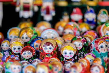 A lot of Matryoshka at souvenir market shop. Different colors Russian dolls. Traditional classic Russian handicraft art background. Famous classical and modern Russian dolls Matryoshka toys