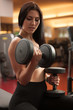 © Samo Trebizan - Active young woman workout with dumbbells in fitness club gym