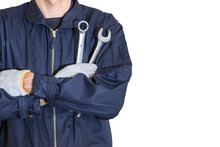 Car Repairman Wearing A Dark Blue Uniform Standing And Holding A Wrench That Is An Essential Tool For A Mechanic Isolated On White Background.