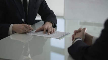 Wall Mural - Businessman giving male colleague cooperation contract for signing, partnership