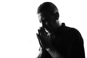 Male person silhouette over white covering his face with hands