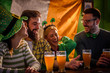 © lordn - Group of Friends Celebrating St Patrick's Day in Beer Pub
