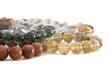 Beautiful translucent assorted colors Rutilated Quartz or Venus’ hairstone bead in bracelets on white background