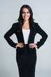 Perfect business woman. Beautiful young businesswoman looking at camera with smile while standing against white background