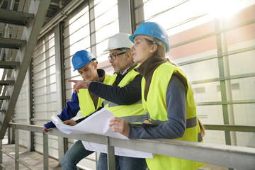 Wall Mural - Construction site manager with young people in training period