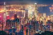 Scenic view over Hong Kong island, China, by night. Multicolored nighttime skyline with illuminated skyscrapers seen from Victoria Peak