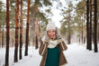 © Юлия Буракова - Beautiful young girl outdoors in winter looking at camera and smiling. Portrait of attractive happy girl outdoors in winter background. Close-up.