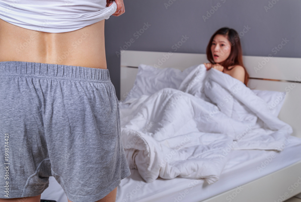 couple in bedroom is having sex, man taking his clothes off with woman