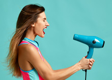 Happy Young Brunette Woman With Hair Dryer On Blue Mint Background