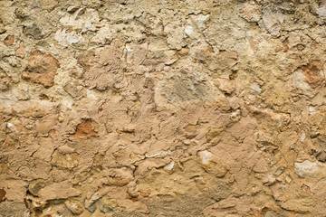 Wall Mural - Stone wall covered with mud