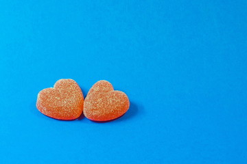 two sweet heart candies on a blue background