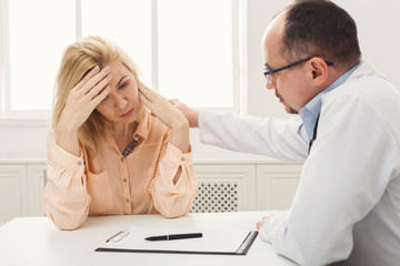 Doctor consulting woman in hospital