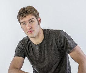 Handsome, young man with confident expression, isolated on white background