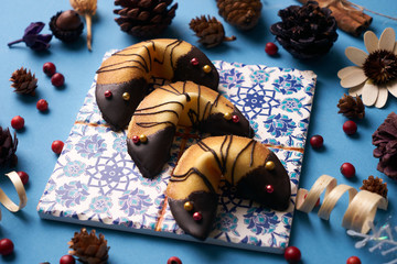 Chinese fortune cookies. Delicious traditional Fortune cookies on a blue background with Christmas decorations, close-up