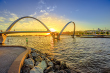 Scenic And Iconic Elizabeth Quay Bridge At Sunset Light On Swan River At Entrance Of Elizabeth Quay Marina. The Arched Pedestrian Bridge Is A New Tourist Attraction In Perth, Western Australia.