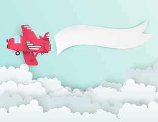 Wall Mural - Airplane aerial view paper art with paper banner for text. Flying origami red plane. Blue sky background with fluffy clouds. Trendy paper art style