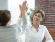 © ASDF - members of the business team giving each other a high five.