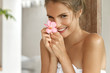 © WHstudio Leushin N - Young cheerful female with pleasant charming smile wrapped in towel, satisfied with new bath lotion, has soft fresh healthy skin after taking shower. Lovely young woman poses indoor in bathroom