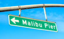 Green And White Street Sign Pointing To Malibu Pier In California