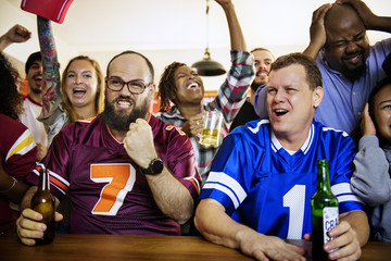 Frieds cheering sport at bar together