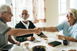 © Rawpixel.com - Casual seniors shaking hands