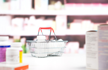 Wall Mural - Pharmacy with medication and shelves. Shopping basket full of medicine and pill bottles on the counter in drugstore. Medical retail business and pharmaceutical industry concept.