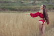 © Petro - Woman enjoys nature in the field, her long hair fluttering in the wind.