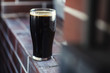 © hiddenhallow - Pint of stout on bricks