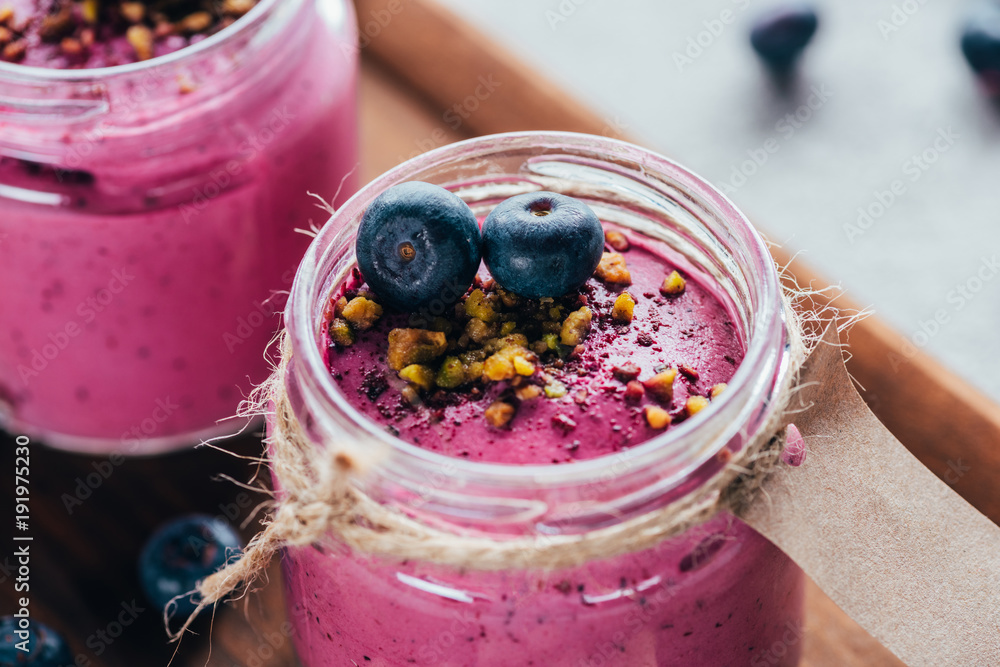 close-up view of sweet healthy smoothie with granola, nuts and berries - obrazy, fototapety, plakaty 