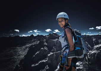 Wall Mural - Young female climber standing in mountains