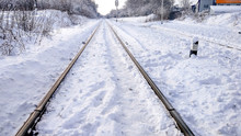 The Path Between The Sleepers In With A Bliss. Sleepers From The Train, Electric Train In City In The Winter. They Are Covered With Snow From A Storm. The Road Going Into The Distance.