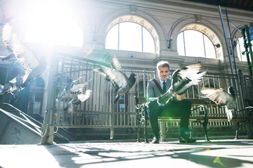 Wall Mural - Mature businessman on a train station.