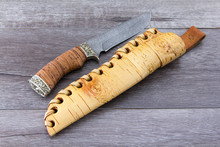 A Knife Made Of Damascus Steel With A Handle And Scabbard From Birch Bark.