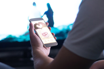 Online dating app in smartphone. Using mobile phone application to meet women. Single man trying to find relationship from internet.