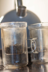 making tea (green tea leaves) in a glass cup, wit two pieces, green tea leaves with hot water in a t