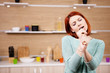 © DC Studio - Redhead woman singing in the kitchen. Lifestyle and happiness