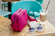 © Connect Images - Handbag, sunglasses and latte on sidewalk cafe table