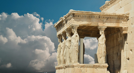 Wall Mural - caryatids in Athens Greece sky clouds