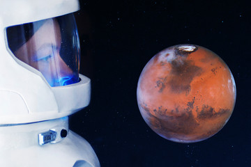 Wall Mural - Development of Mars, concept. Astronaut, looking at the planet Mars. Elements of this image furnished by NASA.